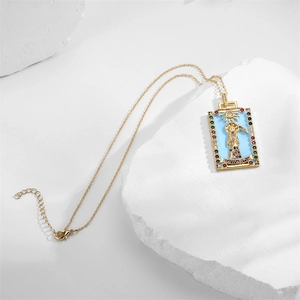 Detailed shot of tarot pendant necklace with blue enamel sun design on white stone