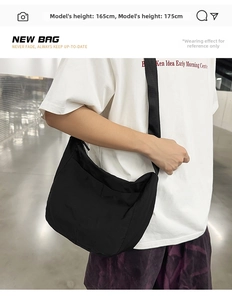 Black large capacity half-moon crossbody bag shown on a person for size reference