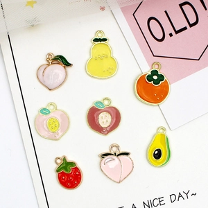 Detail of colorful fruit alloy charms with gold borders for DIY jewelry making