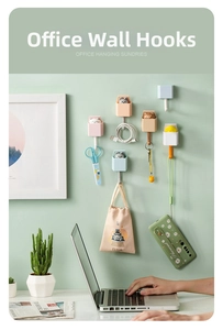 Detail of cute animal wall hooks showing storage for keys, scissors and USB cables