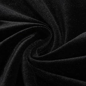 Gros plan du tissu en velours noir premium montrant son lustre doux et son drapé
