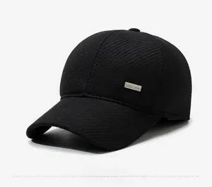 Detail of black wool baseball cap featuring a BEST 1988 metal plaque and twill texture