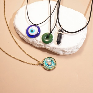 Détail de quatre colliers rétro avec œil de démon et pendentifs en pierre sur pierre