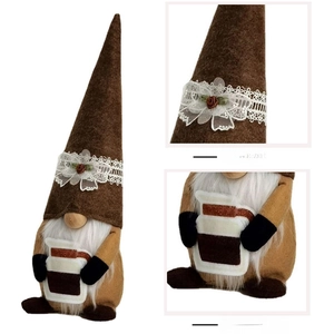 Detailed view of the Christmas gnome plush showing lace hat trim and coffee bottle accessory