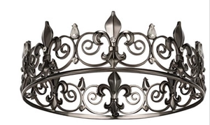 Close-up of a vintage dark metal crown featuring intricate fleur-de-lis and rhinestones