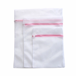 Set of three white mesh laundry bags with pink zippers in small medium and large sizes