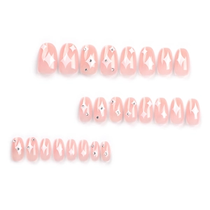 Minimalist pink sheer press-on nails with star patterns and silver rhinestones