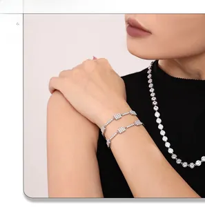 Detailed view of silver geometric bar bracelet and necklace set with cubic zirconia pave
