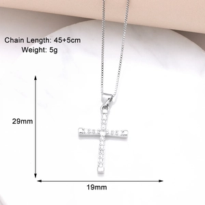 Detail of gold cross pendant with zircons and 45+5cm box chain on marble surface
