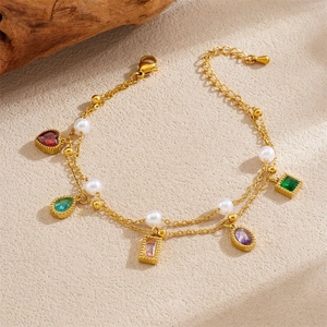 Detail of gold double-layer bracelet with white pearls and colorful gemstone pendants