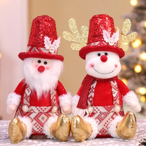 Close-up of plush Santa and reindeer figurines with red sequins and festive details