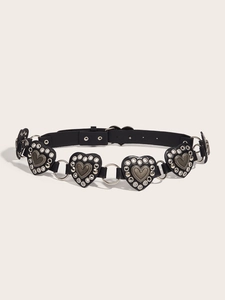Dettaglio di toppe in pelle a cuore con borchie argento e anelli metallici di unione