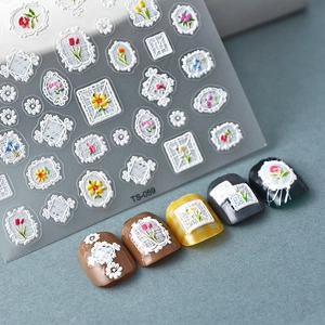 Macro detail of 5D white lace relief nail stickers with tulip and floral border designs