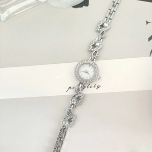Elegant silver swan bracelet watch with sparkling crystals and a round white dial