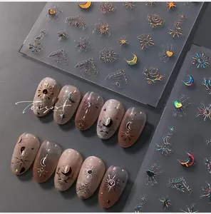 Detail of M-164 laser nail stickers with celestial sun moon patterns and gold foil finish