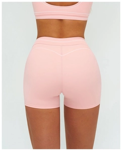 Rear view of high waist pink yoga shorts with contrast white stitching and wide waistband