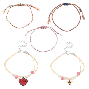 Detail of 5-piece bohemian woven bracelet set featuring heart and bee charms