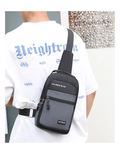 Rear view of a model wearing a three-color panelled oxford fabric chest bag with zippers