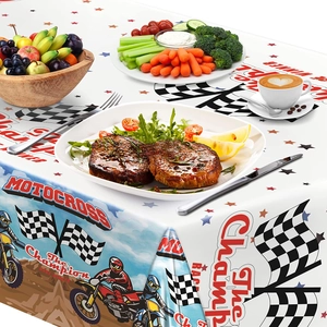 Detail of motocross party tablecloth with racing checkered flags and biker graphics