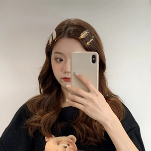 Elegant cellulose acetate hair clip set shown on a model with long brunette wavy hair