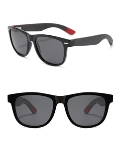Detail view of oval black sunglasses with wooden temples and red interior accents
