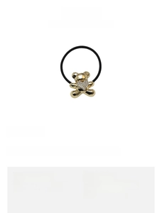 Detail of golden bear hair tie with rhinestone accents and size specifications