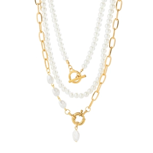 Detail of layered gold necklace with baroque pearls and T-bar toggle clasp design