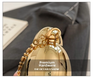 Detailed close-up of premium gold metallic shell bag hardware and bead chain link