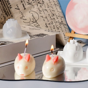 Detailed view of DIY bunny silicone mold and handmade wax candle on vintage background