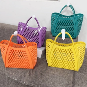 Colorful hollow woven plastic tote bags in orange, purple, green, and yellow on a sofa