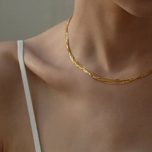 Elegant multi-layer 18K gold plated titanium steel necklace worn on woman's neck
