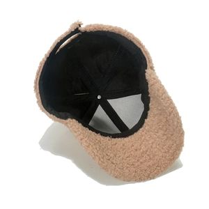 Detail view of the plush beige fleece texture and reinforced inner lining of the baseball cap