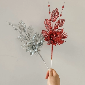 Detail of red and silver Christmas floral stems with glittery berries and petals