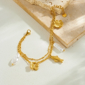 Double-layered gold stainless steel bracelet with butterfly, fish charms and baroque pearls