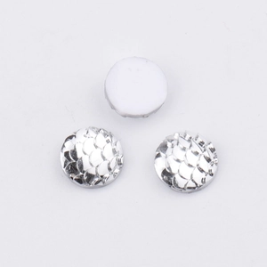 Macro shot of 10mm round resin fish scale cabochons with metallic silver finish