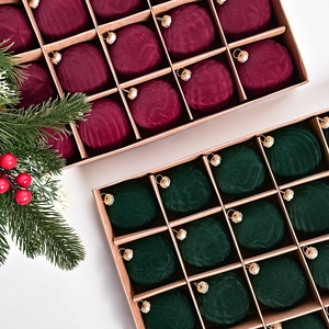 Set of red and green velvet flocked Christmas balls with gold hanging loops for holiday decor