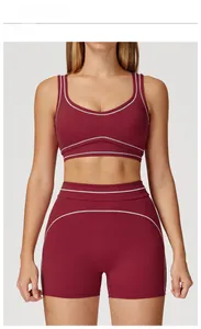 U-neck cherry red sports bra and high-waisted shorts set with contrasting topstitching