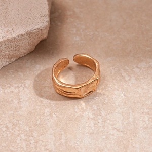 Detail of irregular textured surface on adjustable gold-plated geometric ring