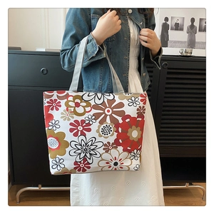 Close-up of durable canvas tote bag featuring vibrant vintage floral print and fabric handles