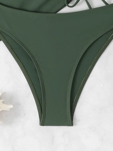 Detail of dark green tankini bottoms with precision double stitching on matte fabric