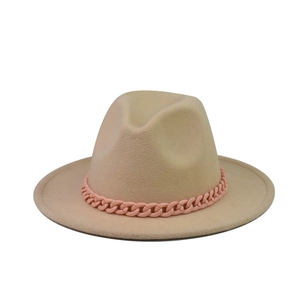 Detail shot of a beige wool fedora hat featuring a chunky pink chain decoration
