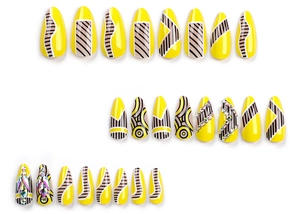 Macro detail of yellow geometric press-on nails with glitter stripes and rhinestones