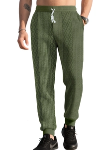 Close-up of olive green waffle knit texture and drawstring waistband on joggers