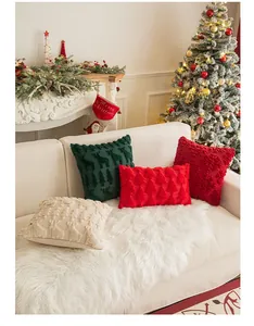 Detailed view of festive Christmas pillows with embroidered reindeer and plush textures