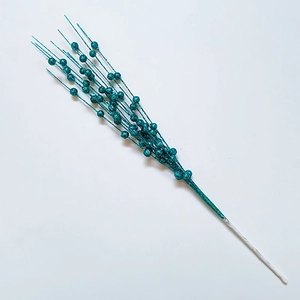 Detailed view of teal glittered artificial berry stems for festive Christmas decoration