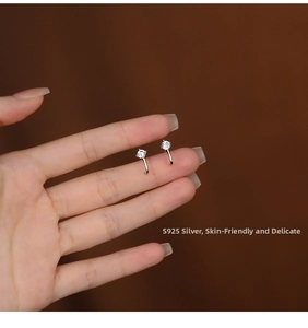 Detailed view of S925 silver curved stud earrings featuring four-claw set clear zircon stones