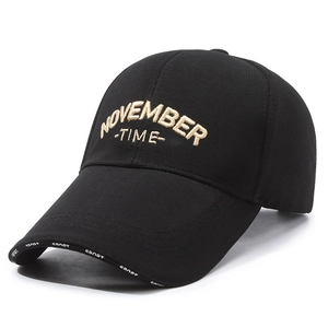 Classic black baseball cap with gold November embroidery and a curved brim
