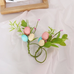Easter egg napkin rings set with colorful speckled eggs and green leaves for table decor