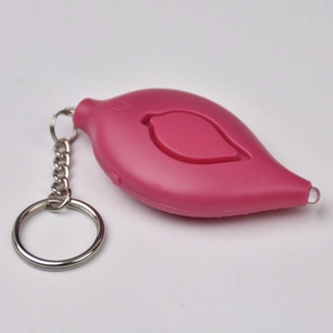 Close-up of pink leaf-shaped personal alarm with integrated LED light and metal keychain