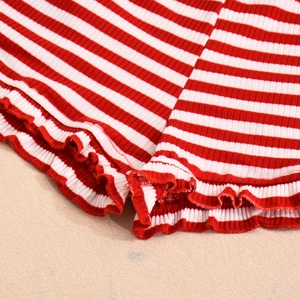 Close-up of red and white striped ribbed knit fabric with delicate lettuce edge detail